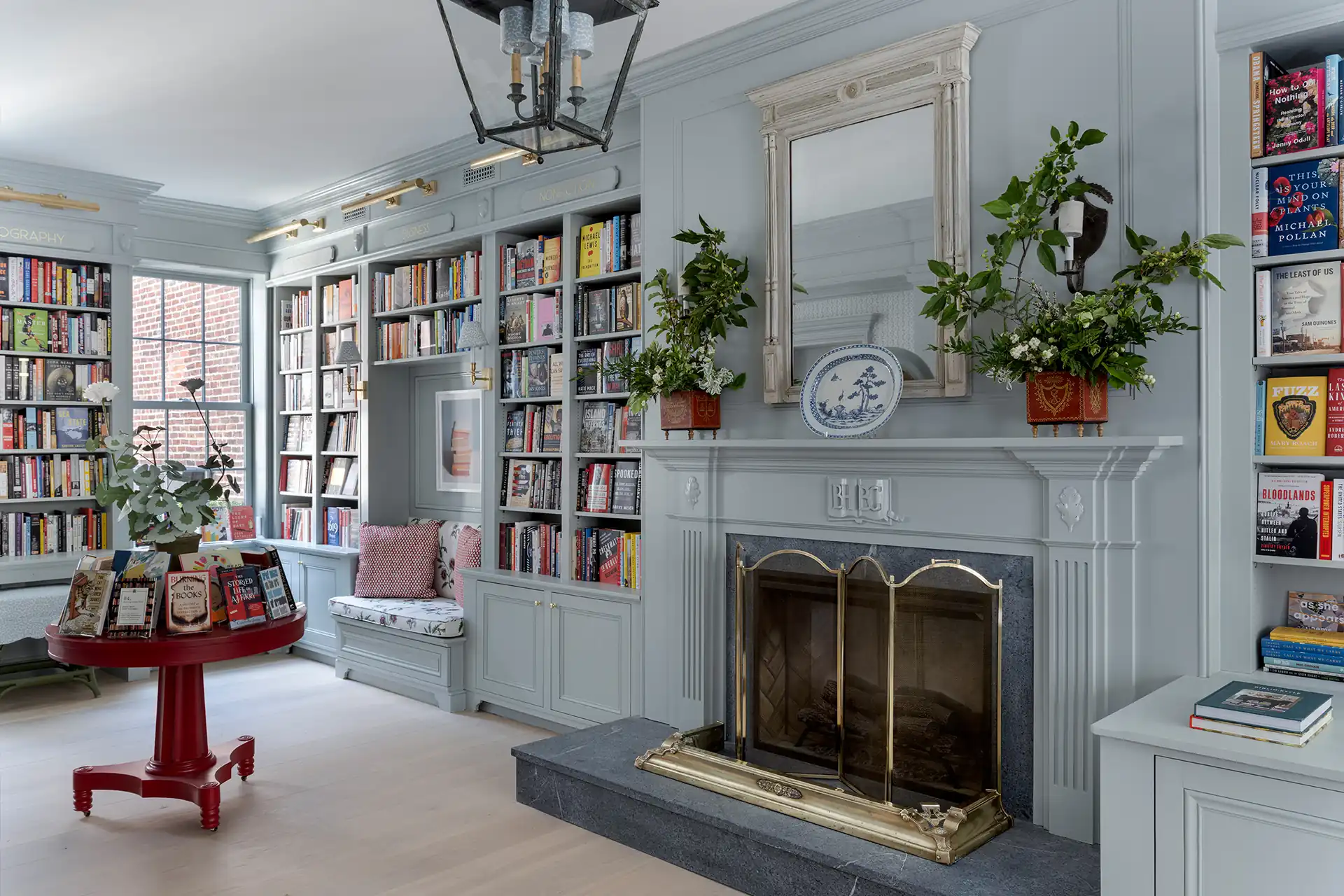 Fireplace reading room with custom bookshelves at Beacon Hill Books & Café in Boston.