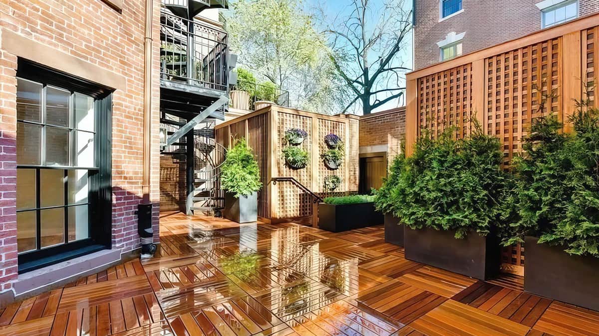 Boston townhouse architecture with brick exterior, private terrace, wood decking, trellis screening, and urban residential design details