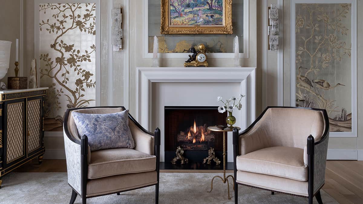 Elegant residential interior with fireplace, wall paneling, decorative finishes, and refined architectural detailing