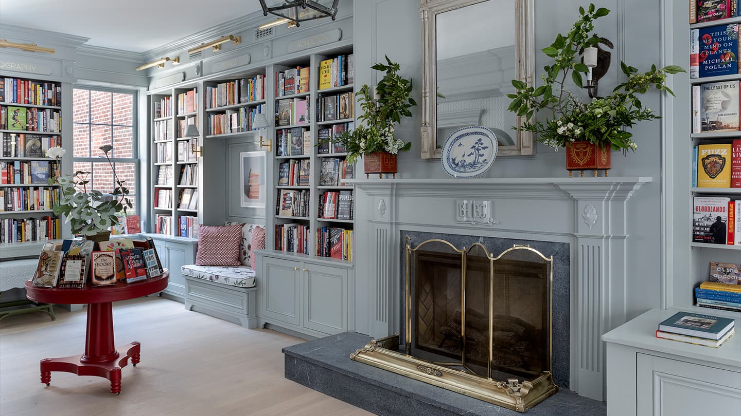 Fireplace reading room with custom bookshelves at Beacon Hill Books & Café in Boston.
