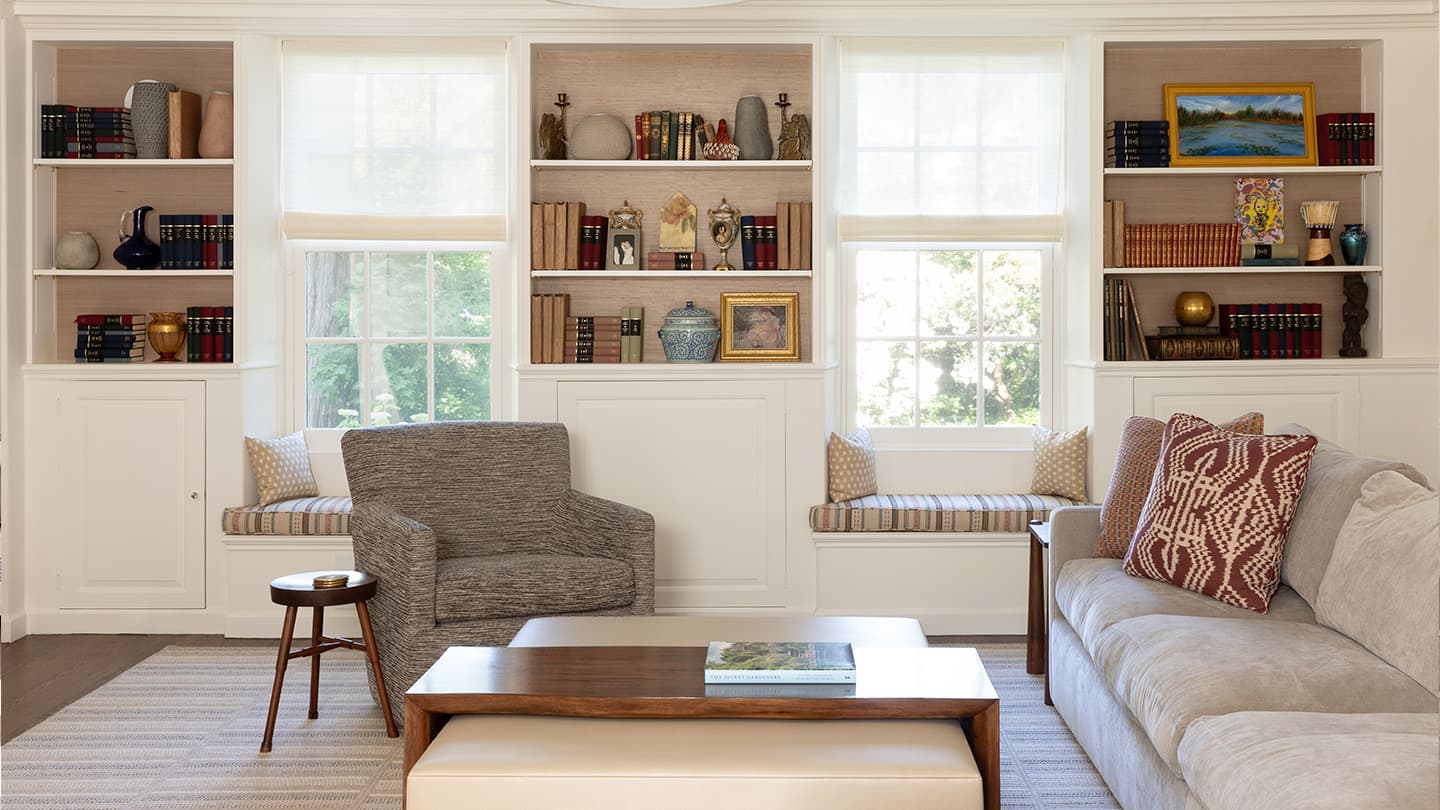 Interior living room at the Belmont Residence in Belmont, Massachusetts, with custom built-in bookcases, window seating, and refined architectural detailing