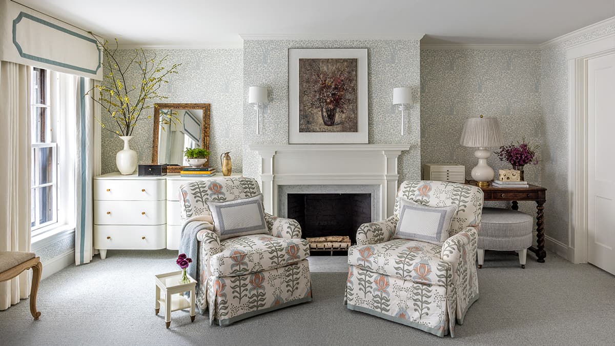 Interior sitting room at the Myrtle Street Townhouse in Boston with fireplace, detailed trim, patterned wallcovering, and custom window treatments